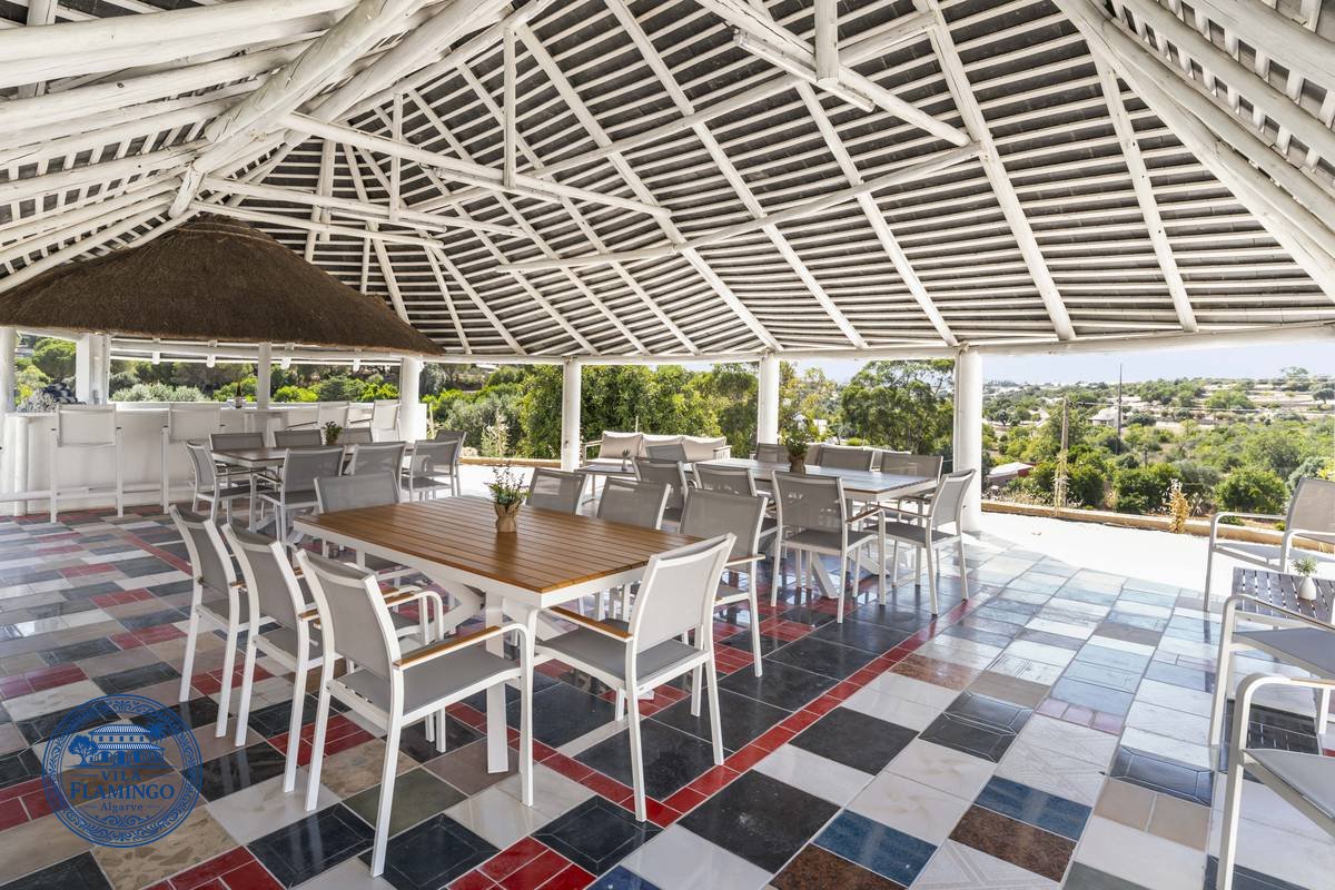 The covered pergola at Vila Flamingo, set for dinner